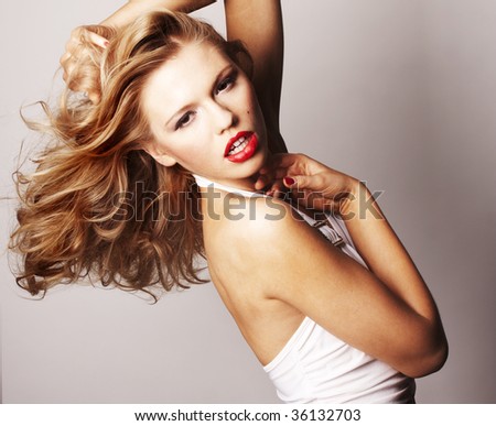 sexy blond girl with red lips on grey background