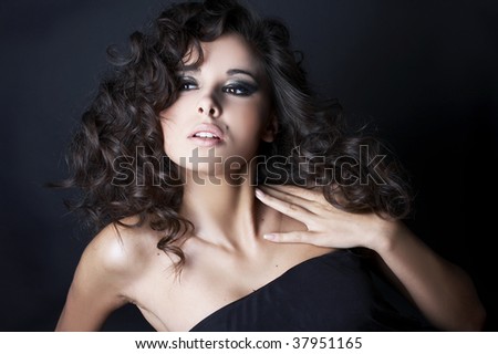 beautiful brunette posing on black background in studio.