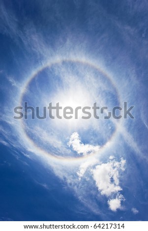 Sun with circular rainbow - sun halo occurring due to ice crystals in atmosphere