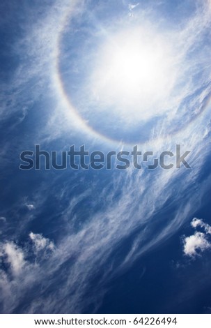 Sun with circular rainbow - sun halo occurring due to ice crystals in atmosphere