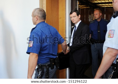 PRAGUE - AUGUST 14: Czech politician David Rath (in the middle) guided by the prison service to court, Prague, Czech republic, August 14, 2013. Rath is accused of corruption.