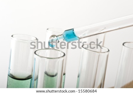 blue drop from a pipette in a science lab