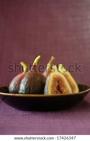 still life three whole figs and one sliced in a japanese bowel