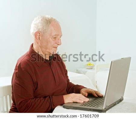 senior man with laptop computer at home