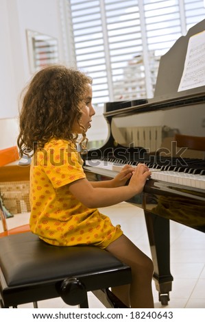 cartoon girl playing piano. stock photo : little girl