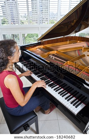 women pianist playing on a grand piano