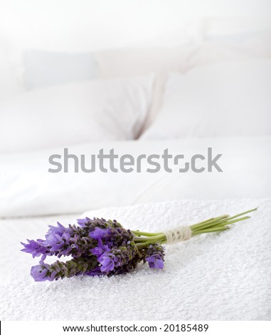bouquet of lavender on a white towel on a bed