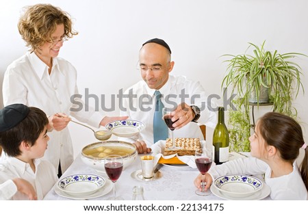 father mother son and daughter in seder celebrating passover