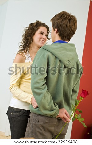 teenager boy giving rose to girlfriend