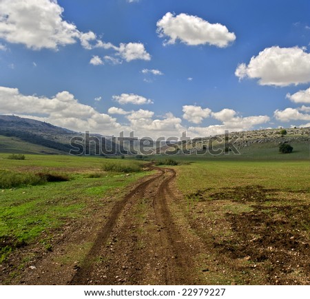 winding dirt road and cloudscpe