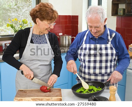 senior couple cooking at their kitchen at home