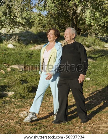 senior couple walking exercise outdoors in woods