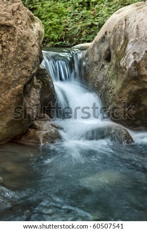 Stream with rocks in motin blur at Kziv river in the Galilee northen Israel