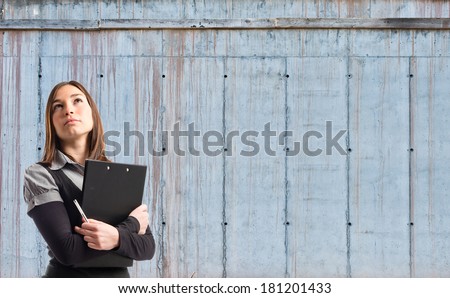 Young student thinking over cement background