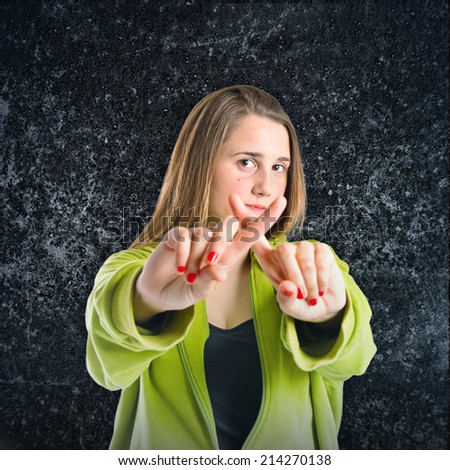 Girl doing NO gesture over black background