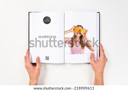 Young girl playing with oranges printed on book