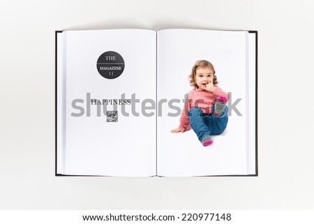 Cute girl sitting and laughing printed on book