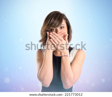 Women with her mouth closed by her hands