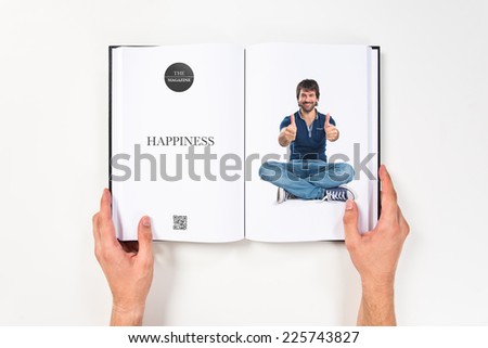 Man with thumb up printed on book