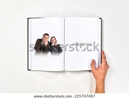 Couple doing surprise gesture printed on book