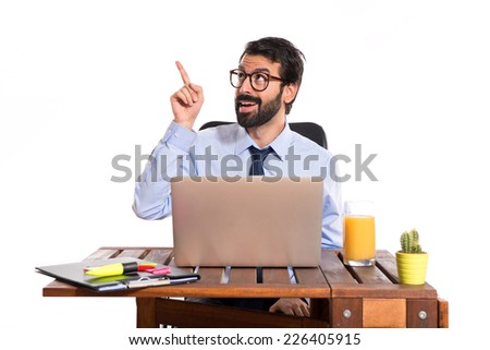 Businessman in his office thinking over white background