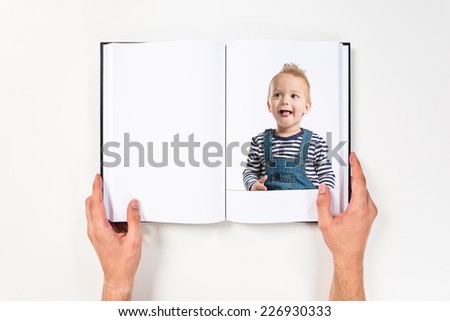 Happy blonde kid printed on book