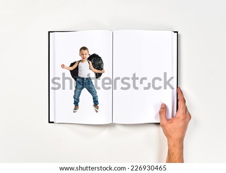 Kid with black wings printed on book