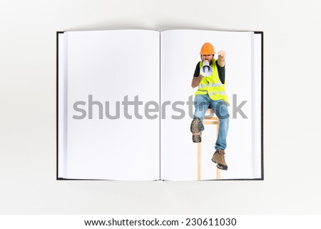 Workman shouting printed on book