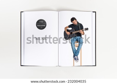 Handsome man with guitar printed on book