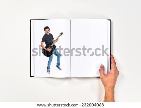 Handsome man with guitar printed on book