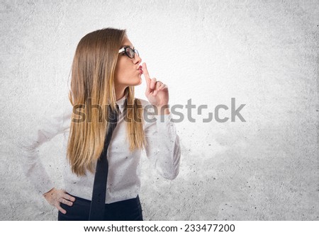 Young businesswoman making silence gesture over isolated white background