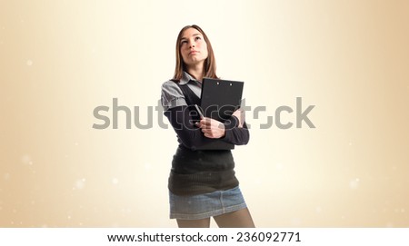 Young student thinking over ocher background