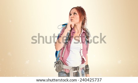 backpacker thinking over isolated ocher background