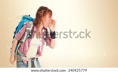 backpacker shouting over isolated ocher background