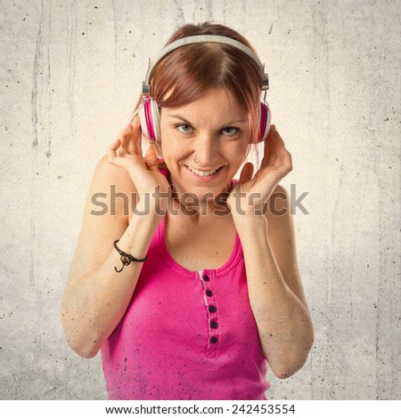 Young girl listening music over textured background