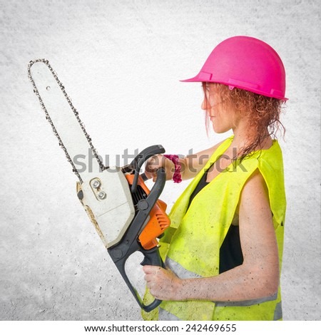 Worker woman with chainsaw over textured background