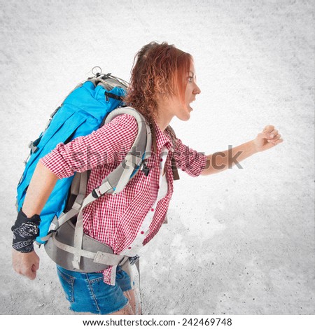 backpacker running fast over textured background