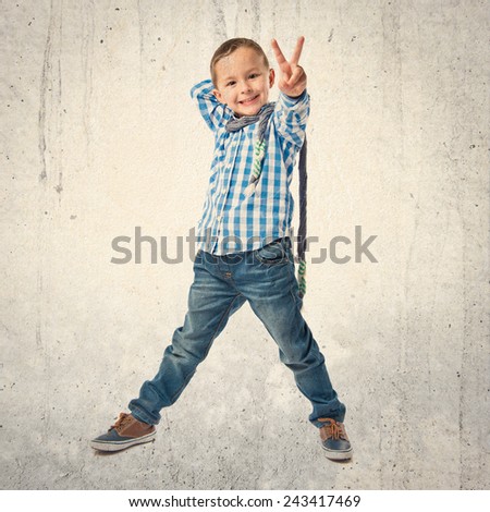 Kid making victory sign over white background
