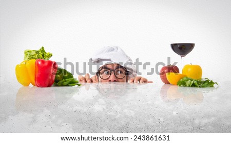 Crazy hipster chef hiding behind the table
