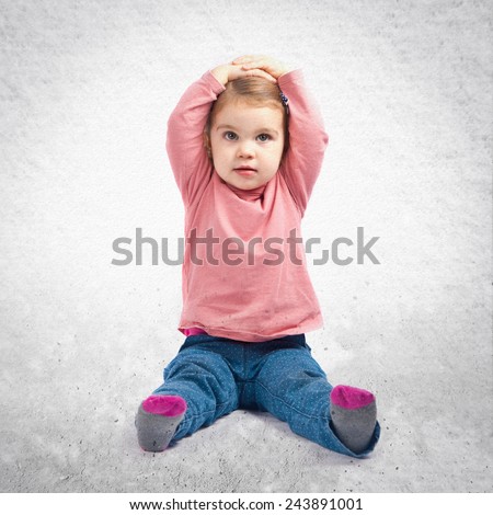 Cute baby girl surprised over textured background