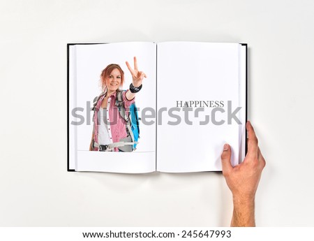 backpacker doing victory gesture printed on book