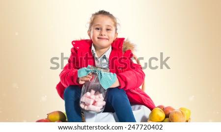 Blonde girl holding jar glass with sugars inside