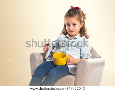 Blonde cute girl holding a cup of tea