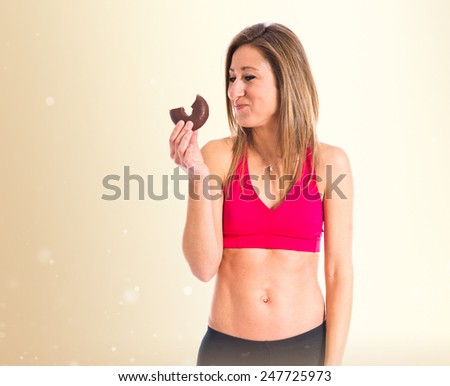 Sport woman eating a donut