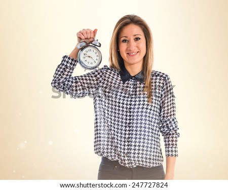 Woman holding vintage clock