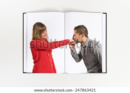 man kissing a woman\'s hand printed on book