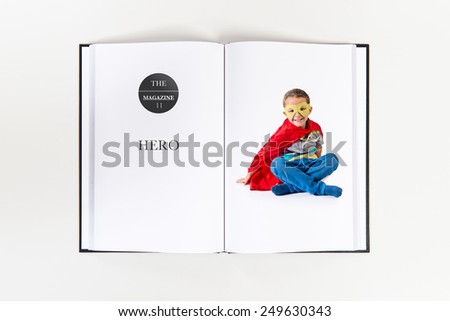 Kid dressed like superhero printed on book