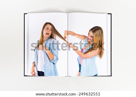 Girls with scissors printed on book