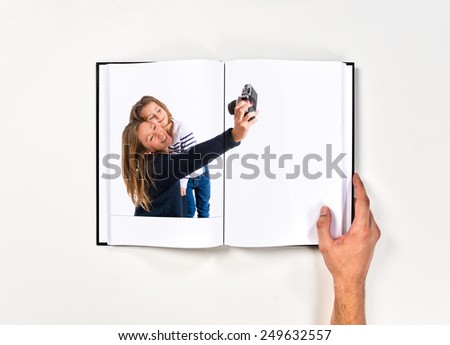 Mother and daughter photographing printed on book