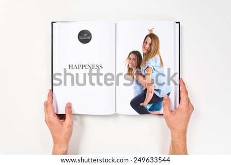 Sisters playing printed on book.